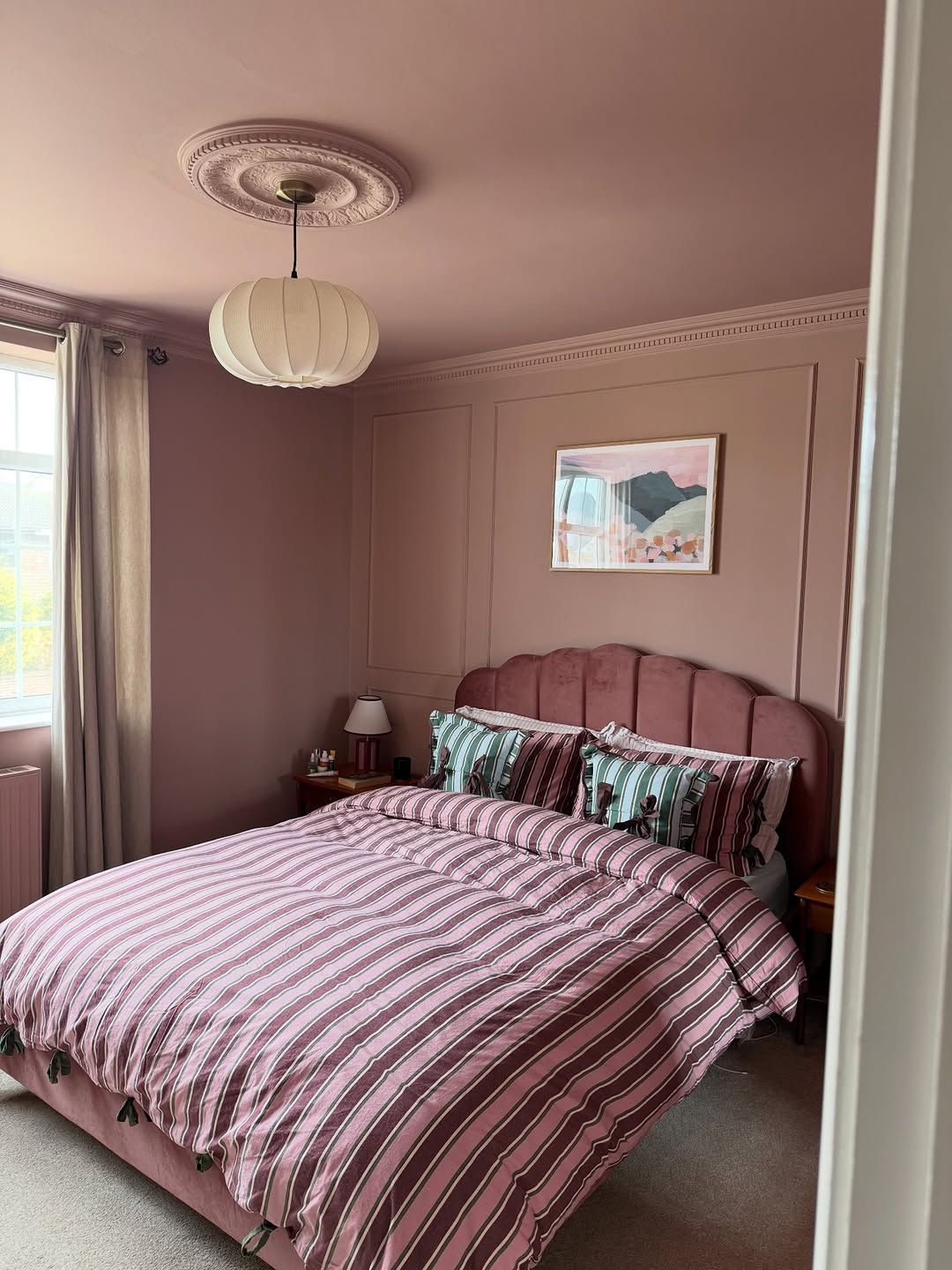 Mauve Walls and Striped Bedding Created a Tonal Bedroom